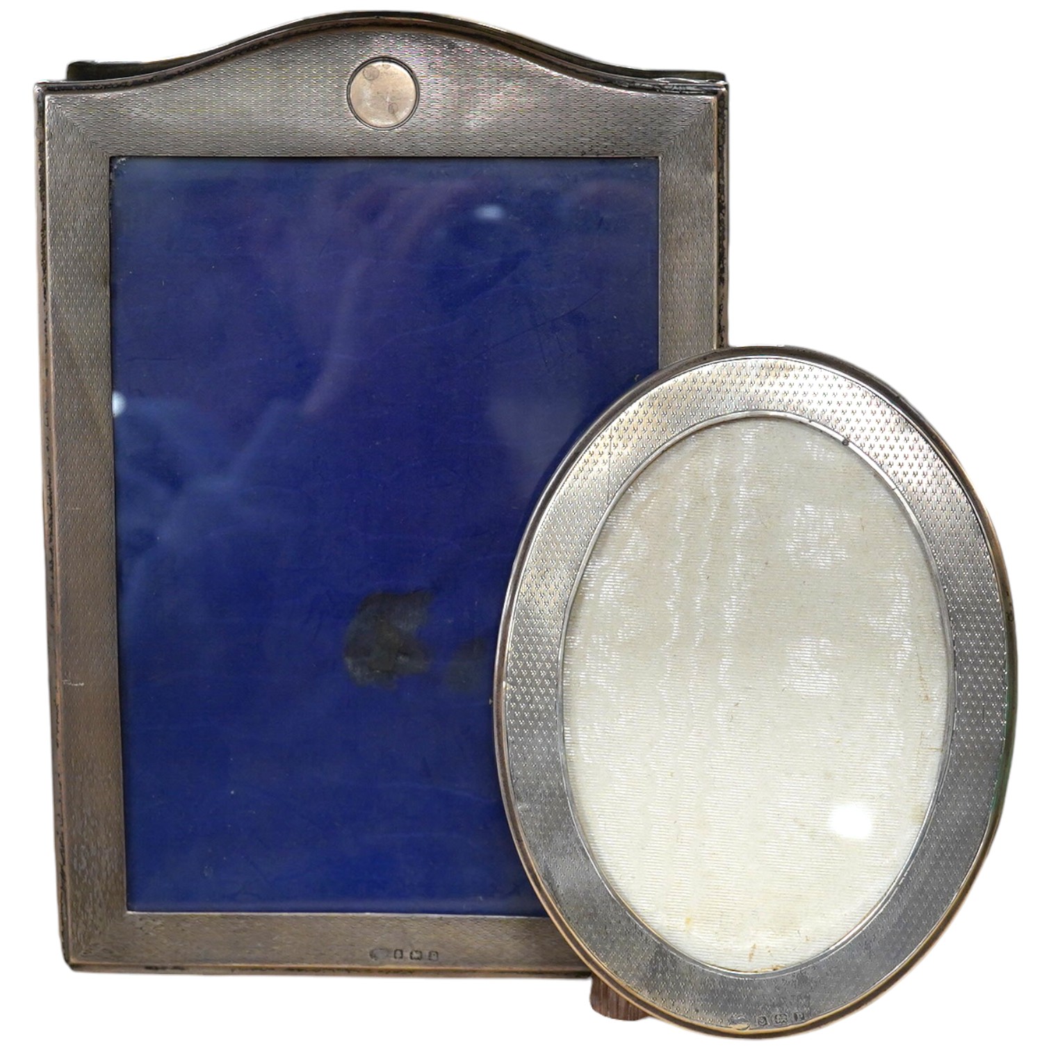 Two George V engine tuned silver mounted photograph frames, Birmingham, 1914, largest 25.1cm. Condition - fair